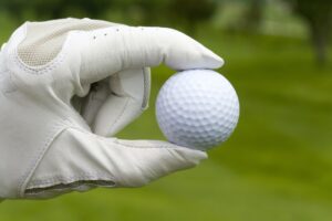 Close-up of a golf ball in golfer's hand