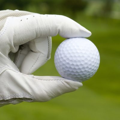 Close-up of a golf ball in golfer's hand