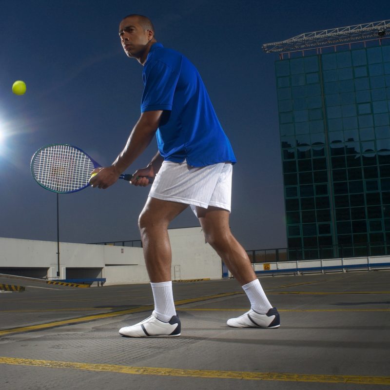 Tennis player on rooftop court